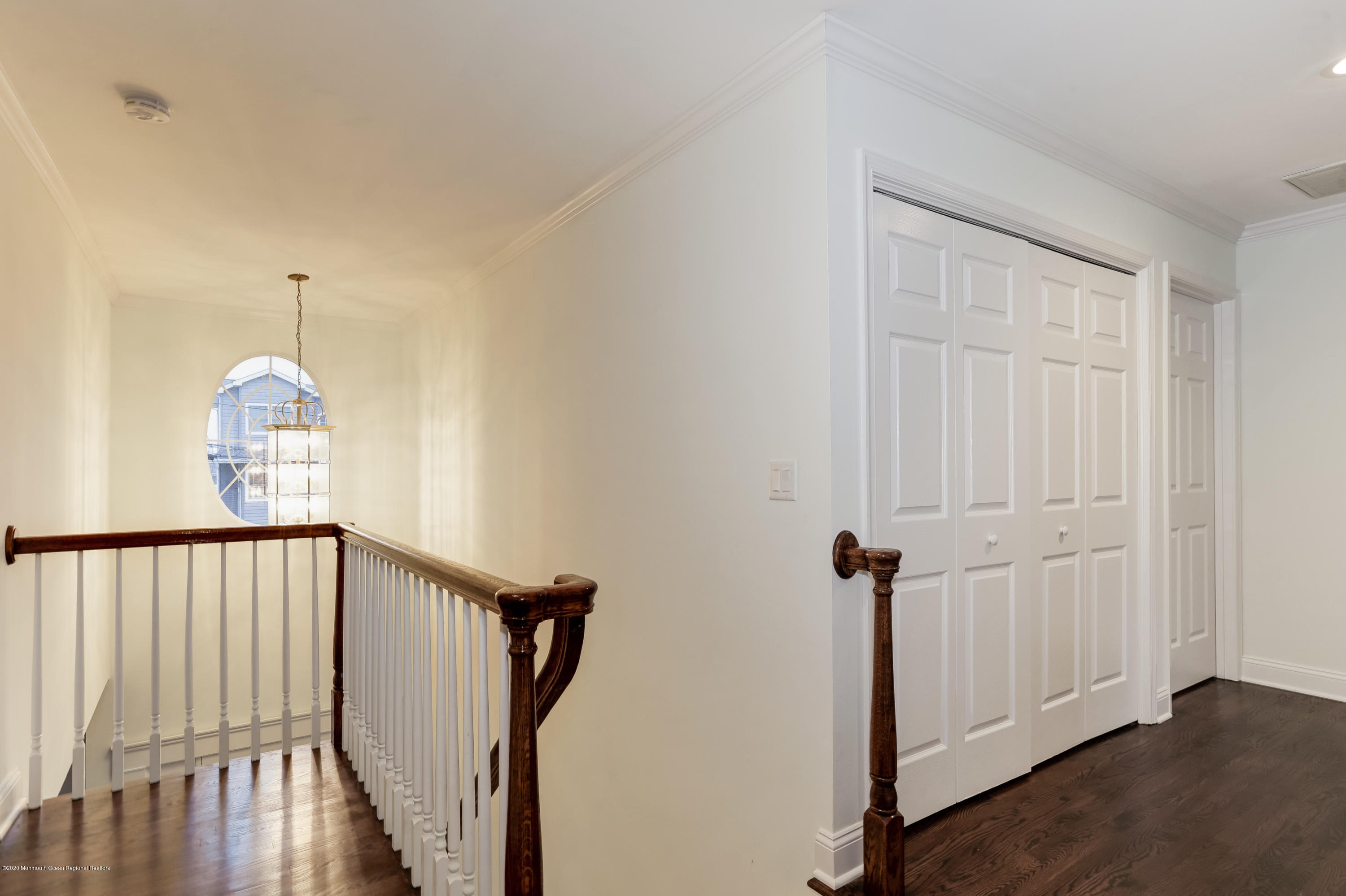 153 Royal Drive Brick, NJ 08723 - Photo 17 of 32 a view of a hallway with wooden floor and staircase