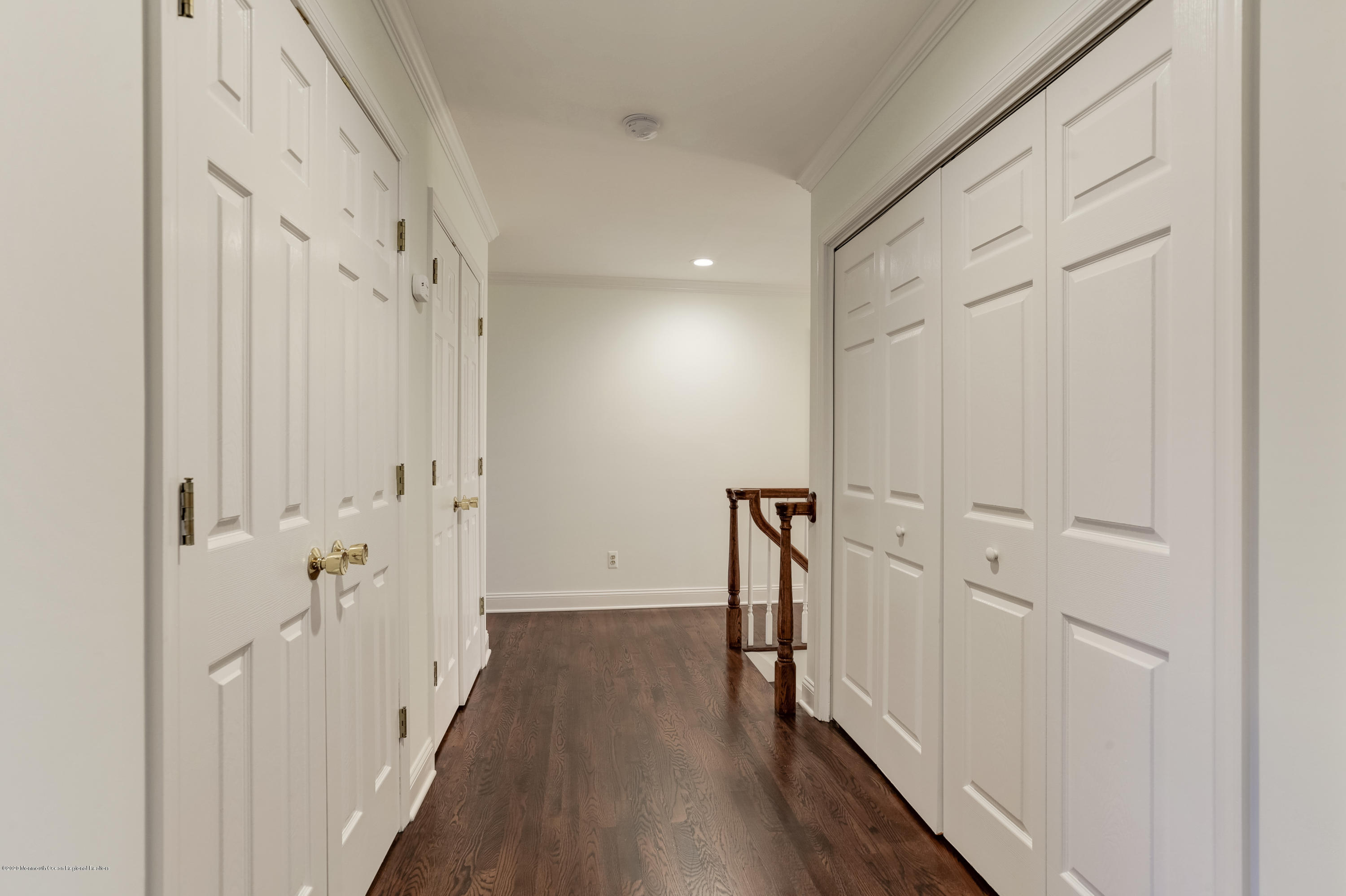 153 Royal Drive Brick, NJ 08723 - Photo 18 of 32 a view of a hallway with wooden floor and staircase