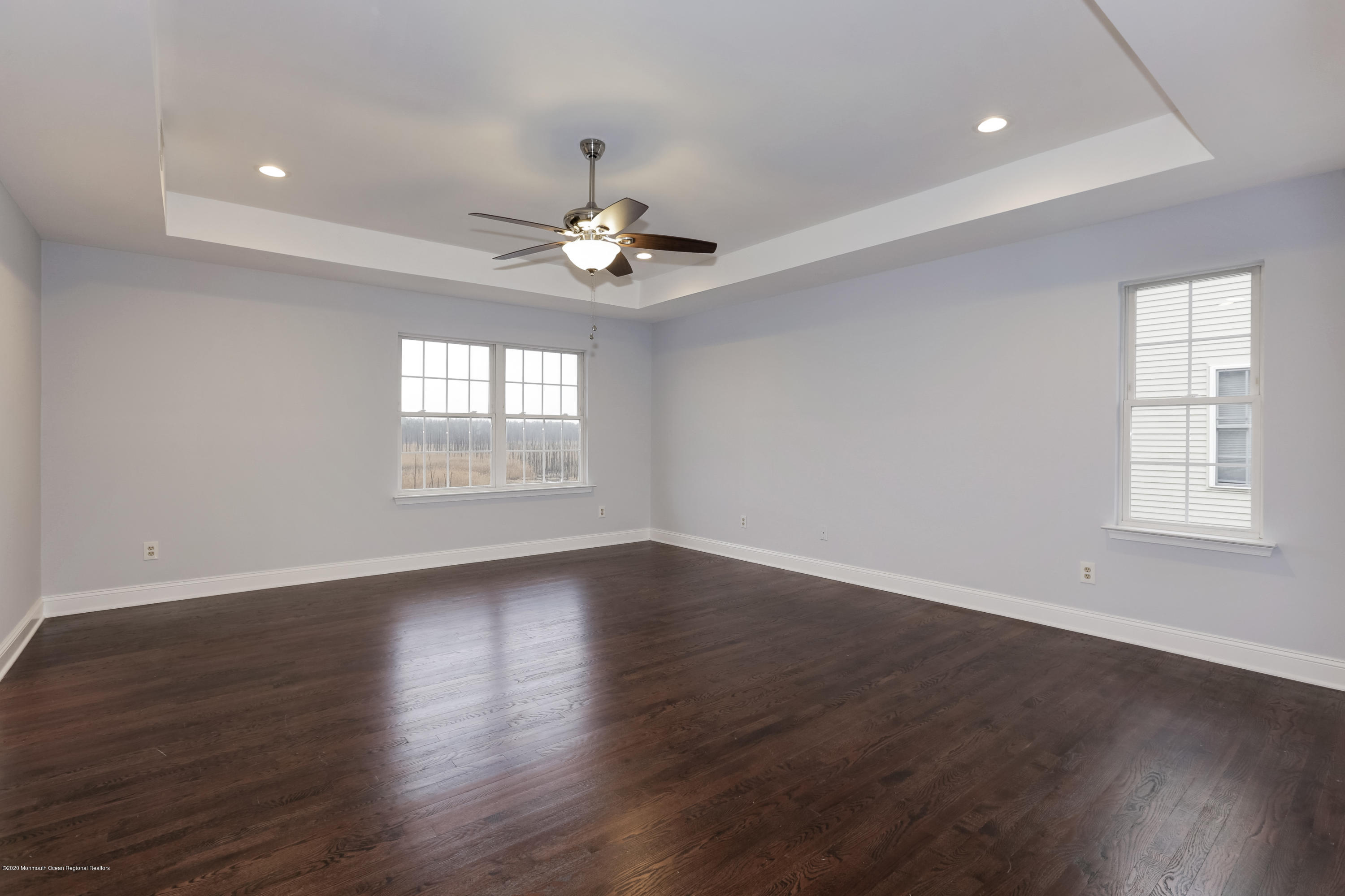 153 Royal Drive Brick, NJ 08723 - Photo 20 of 32 an empty room with wooden floor and window