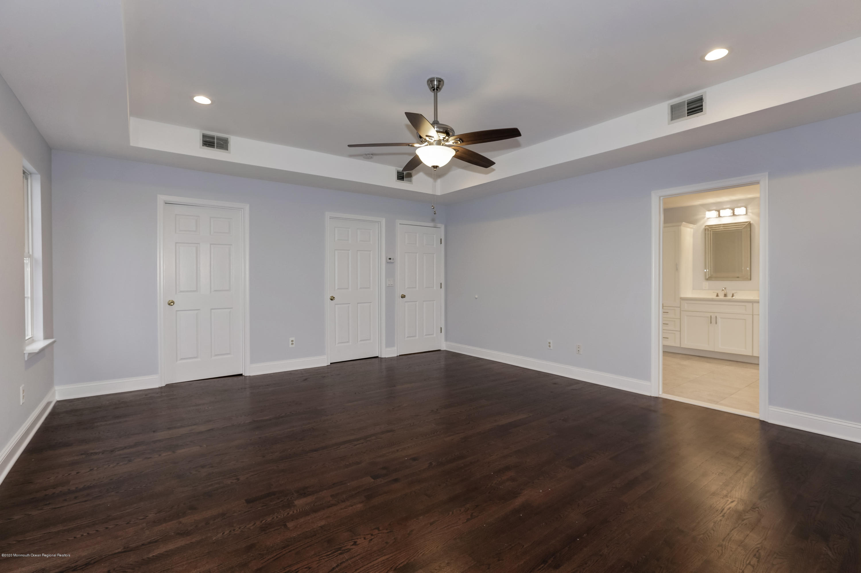 153 Royal Drive Brick, NJ 08723 - Photo 21 of 32 a view of an empty room with wooden floor and a ceiling fan