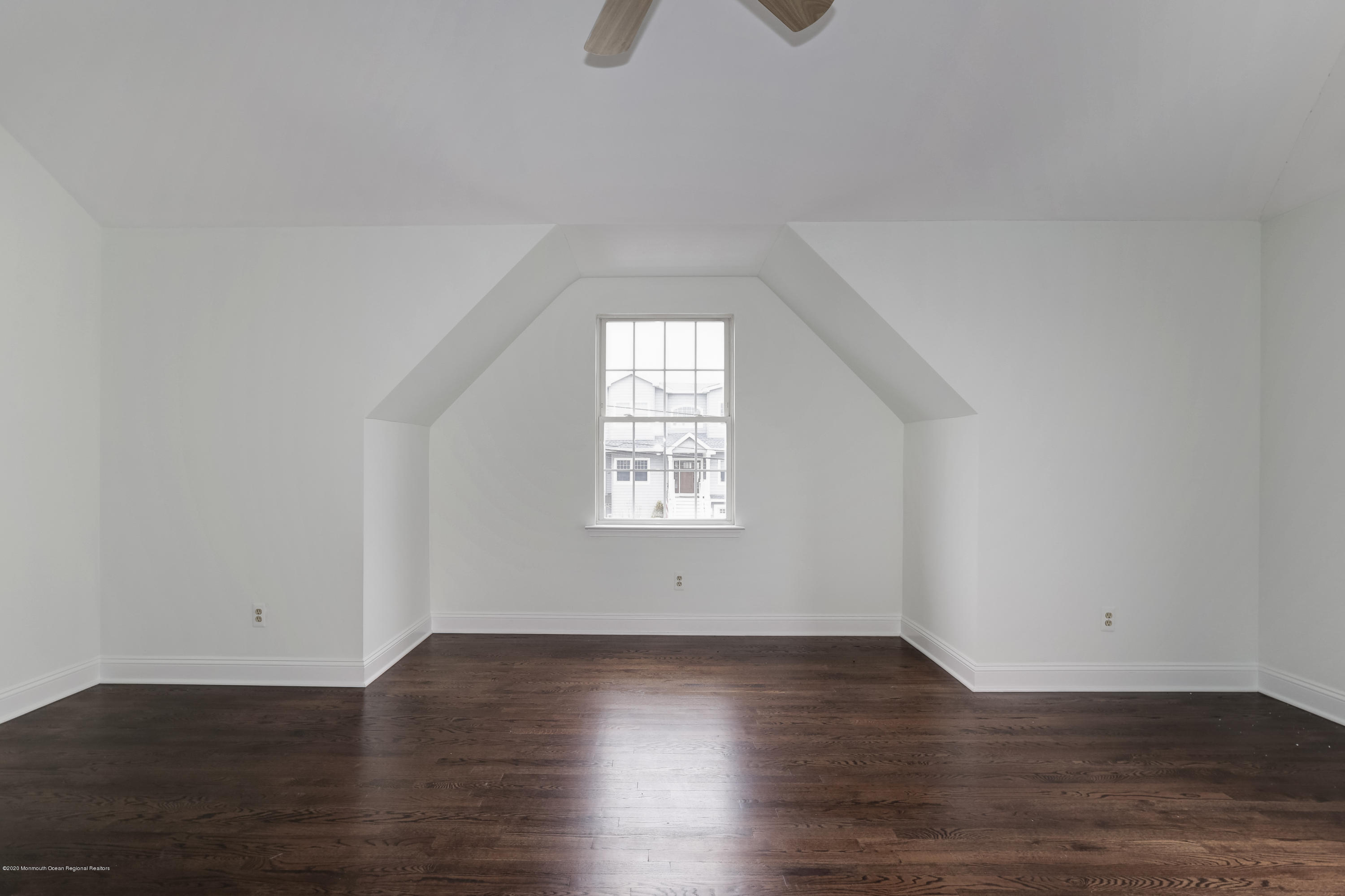 153 Royal Drive Brick, NJ 08723 - Photo 28 of 32 an empty room with wooden floor and windows