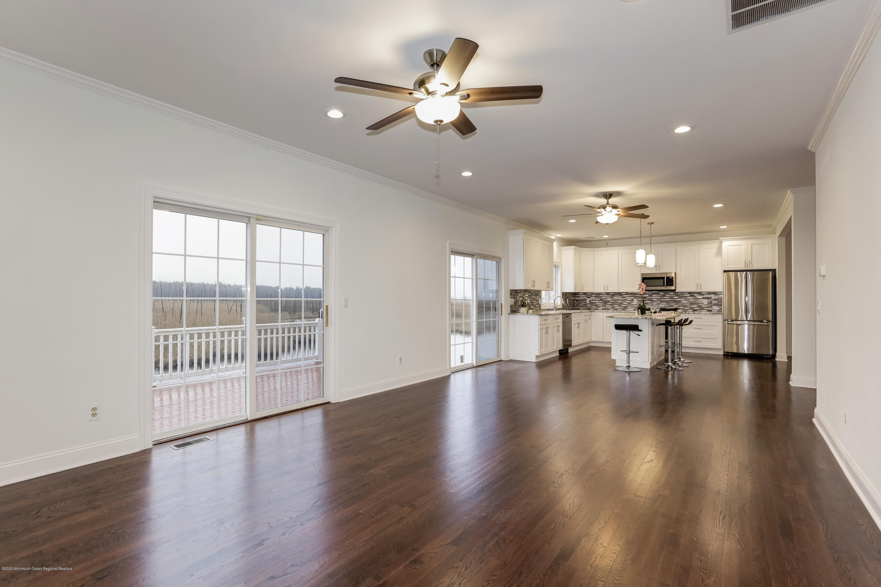 153 Royal Drive Brick, NJ 08723 - Photo 5 of 32 a view of empty room with wooden floor and a ceiling fan