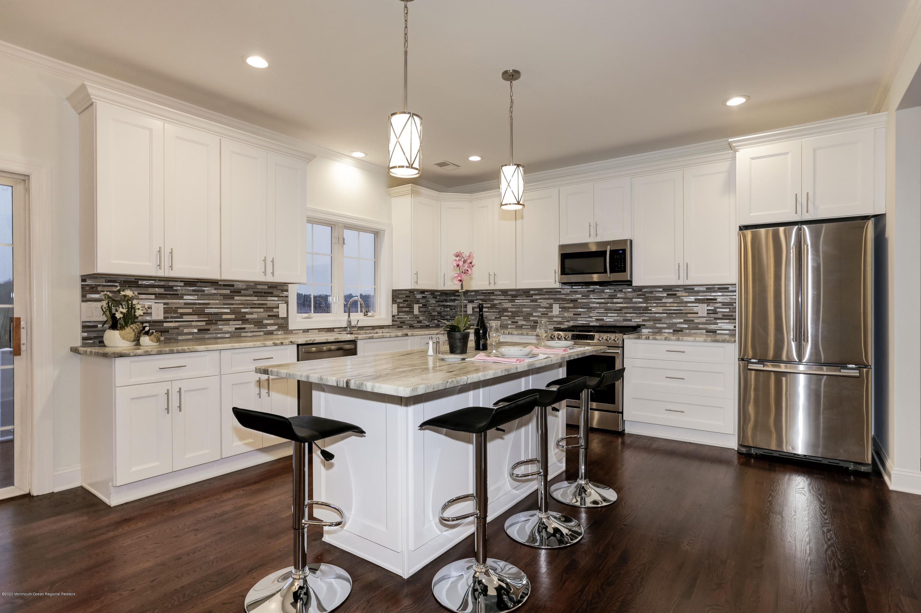 153 Royal Drive Brick, NJ 08723 - Photo 7 of 32 a kitchen with kitchen island granite countertop a sink a center island and stainless steel appliances