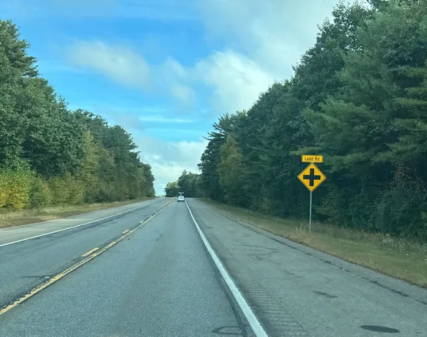 a view of a street with a yard