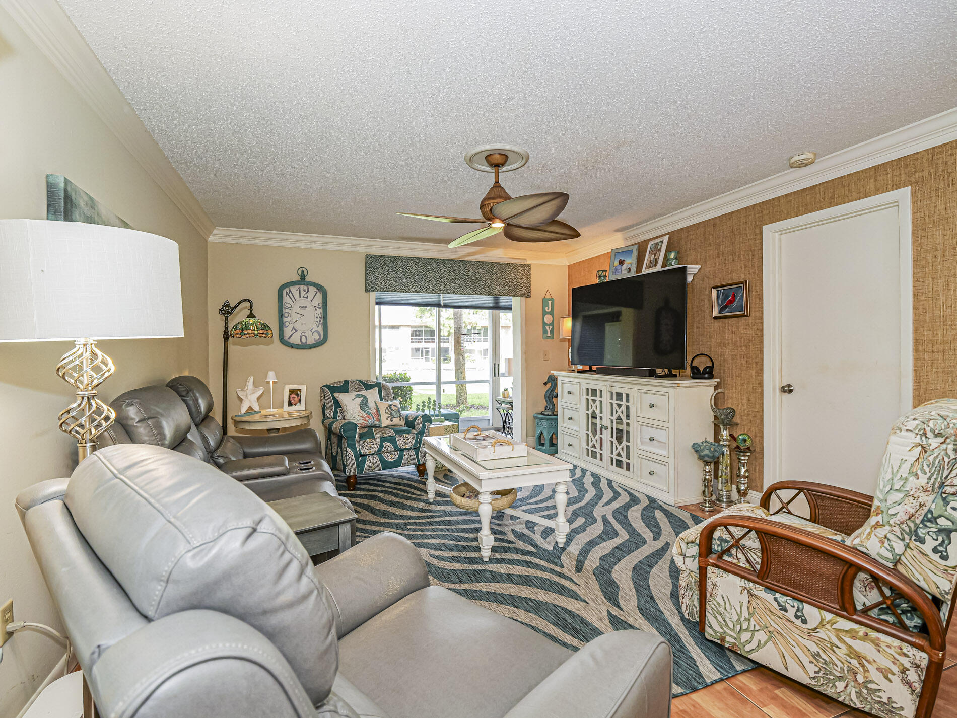 1987 Southwest Palm City Road, Unit BLDG 45 D Stuart, FL 34994 - Photo 8 of 49 a living room with furniture a flat screen tv and a window