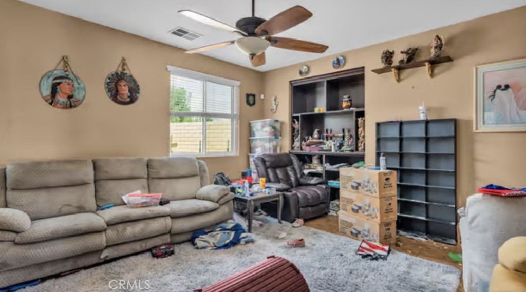 52117 Genoa Street Coachella, CA 92236 - Photo 6 of 35 a living room with furniture a ceiling fan and a window