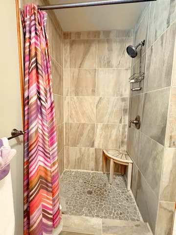a bathroom with a shower and a sink