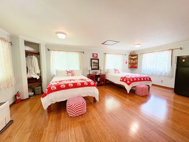 a bedroom with two beds and a couch