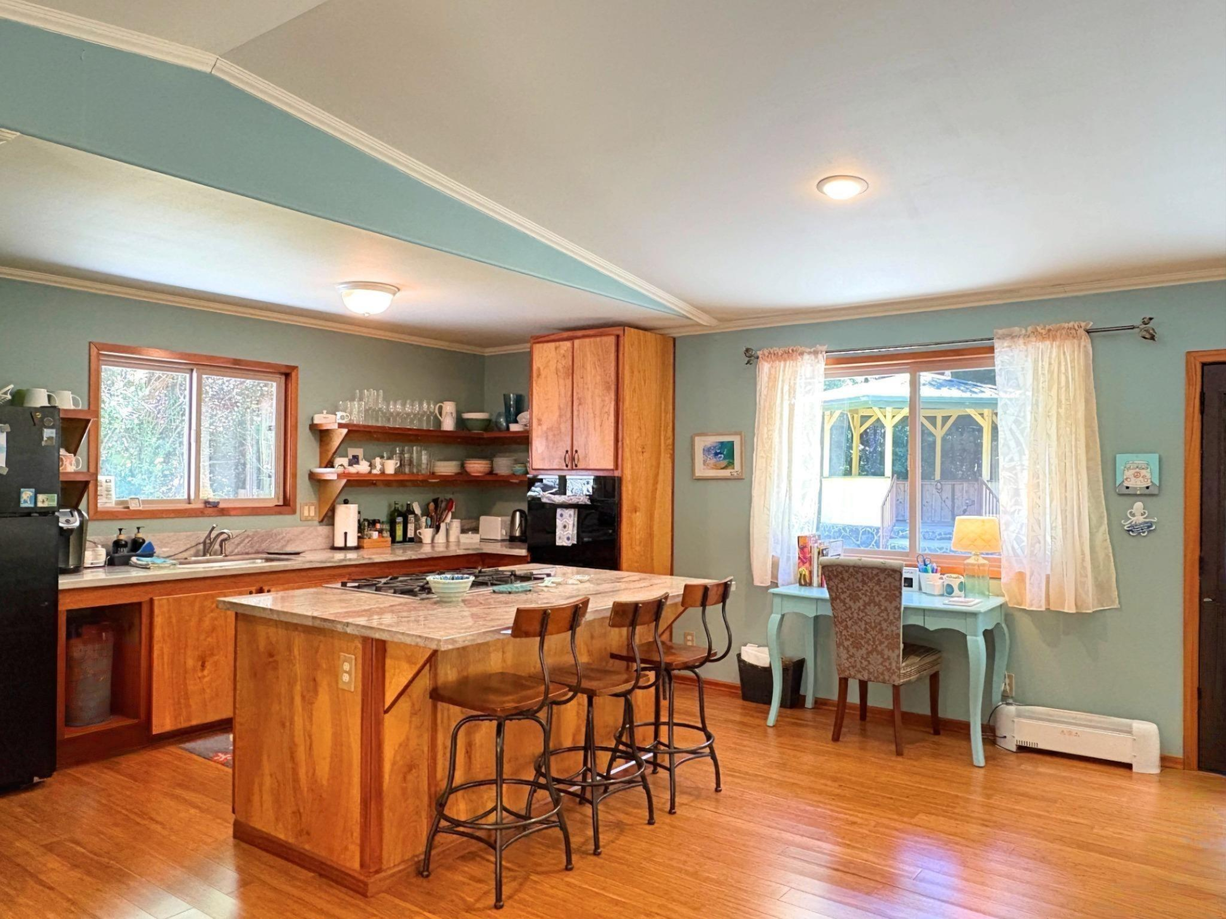 19-4218 Kawailehua Road Volcano, HI 96785 - Photo 5 of 30 a view of a dining room with furniture and wooden floor