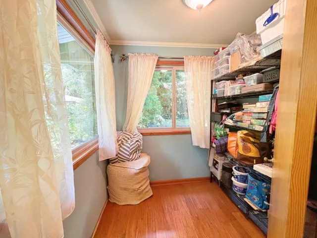 a room with wooden floor and a window