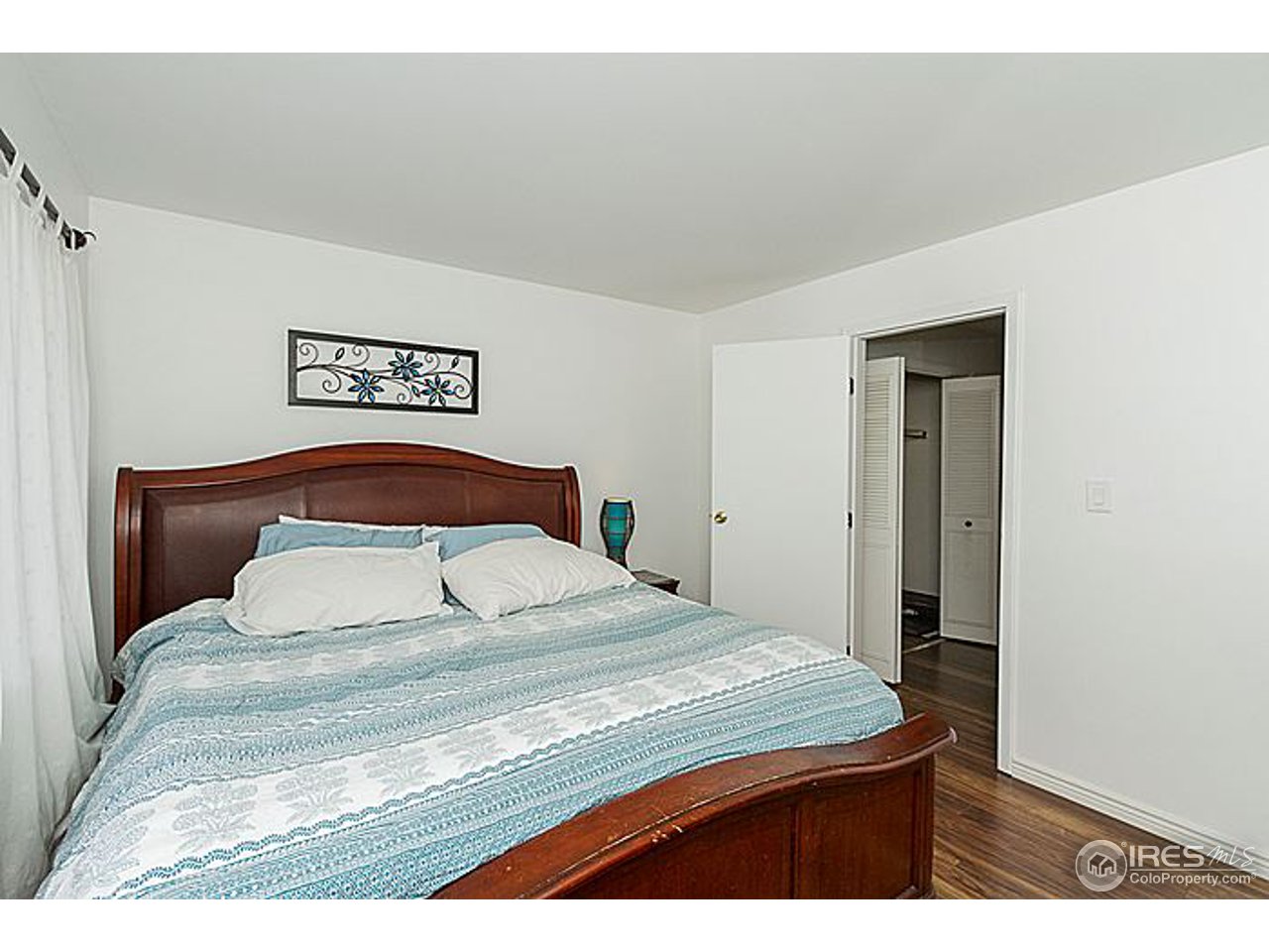 801 East Drake Road, Unit 83 Fort Collins, CO 80525 - Photo 11 of 21 a bedroom with a bed and a night stand