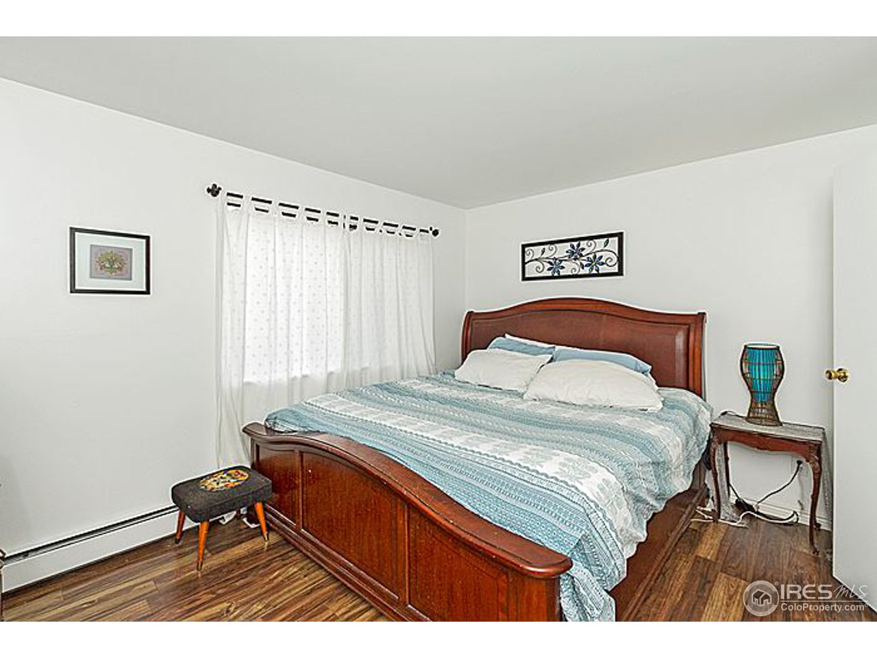801 East Drake Road, Unit 83 Fort Collins, CO 80525 - Photo 12 of 21 a bedroom with a bed and wooden floor