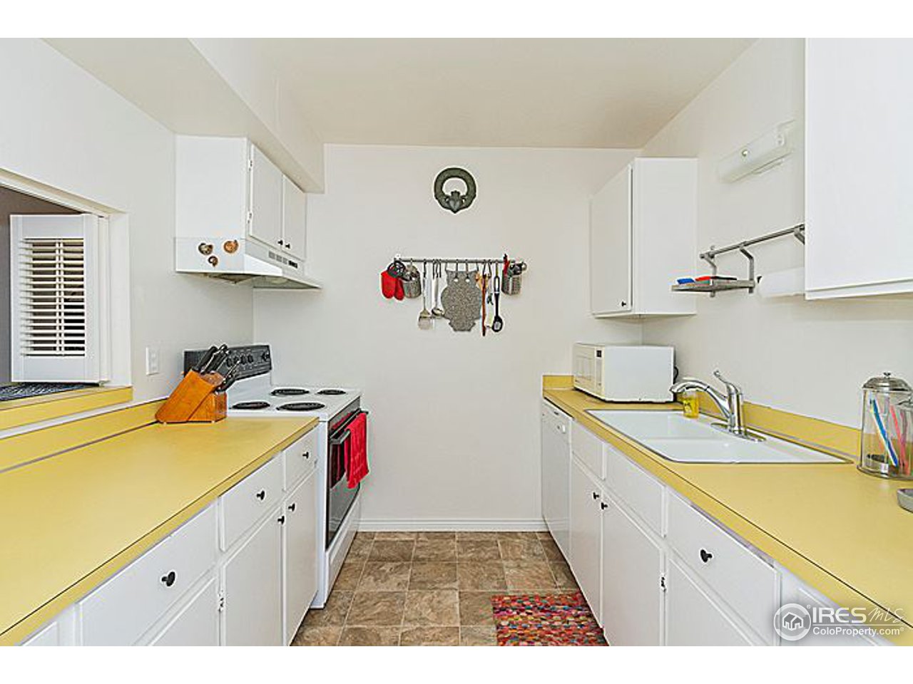 801 East Drake Road, Unit 83 Fort Collins, CO 80525 - Photo 8 of 21 a kitchen with a sink a stove and cabinets