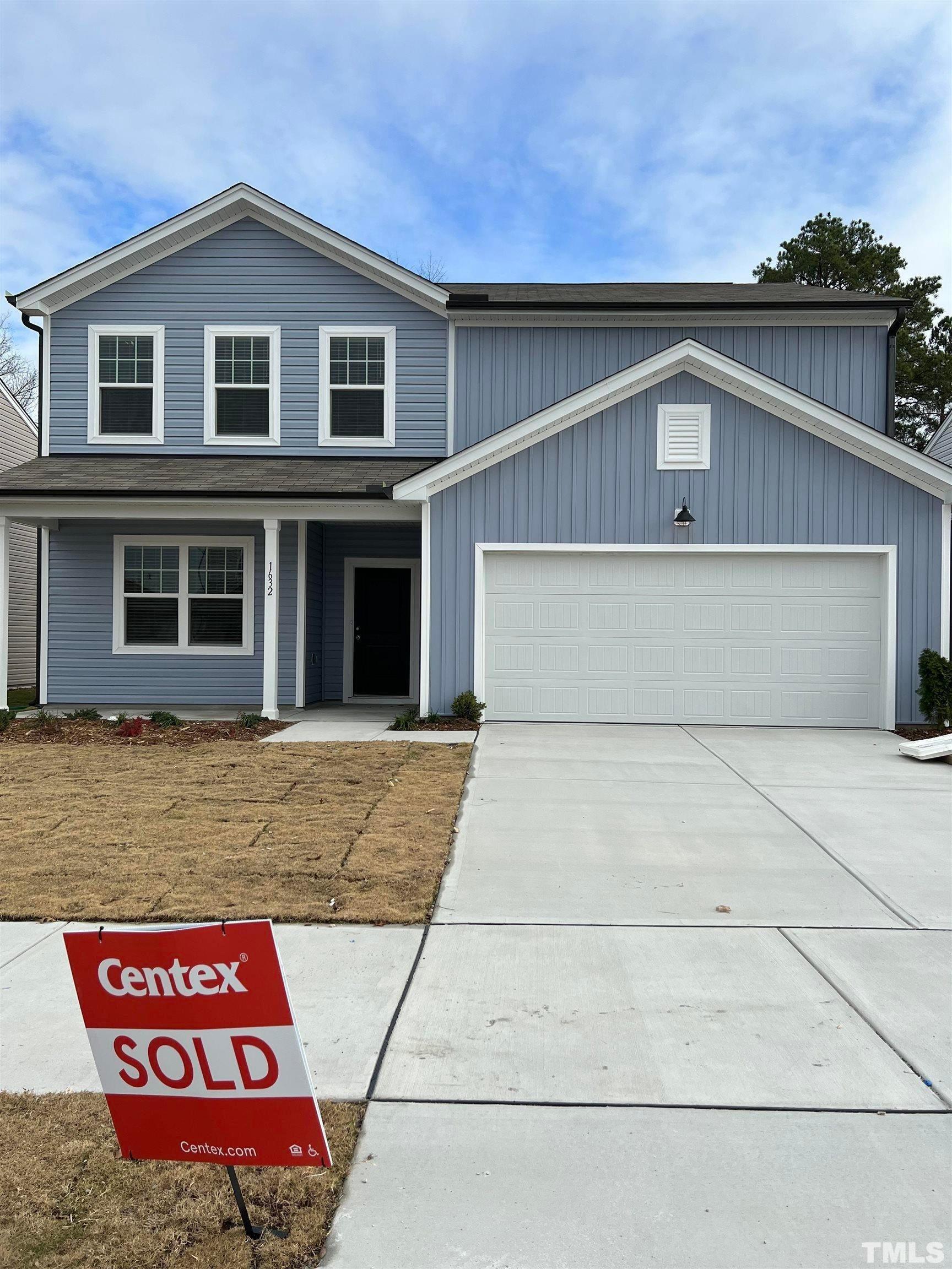 a front view of a house with parking space