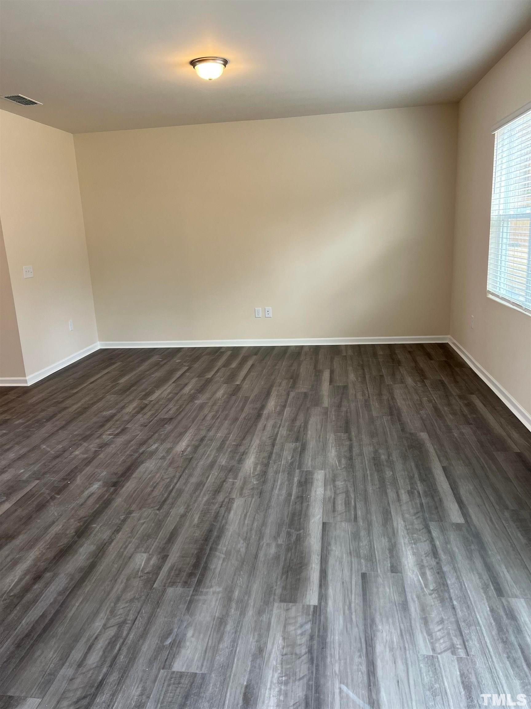 1632 Arapahoe Ridge Drive Raleigh, NC 27604 - Photo 22 of 28 wooden floor in a empty room with a window