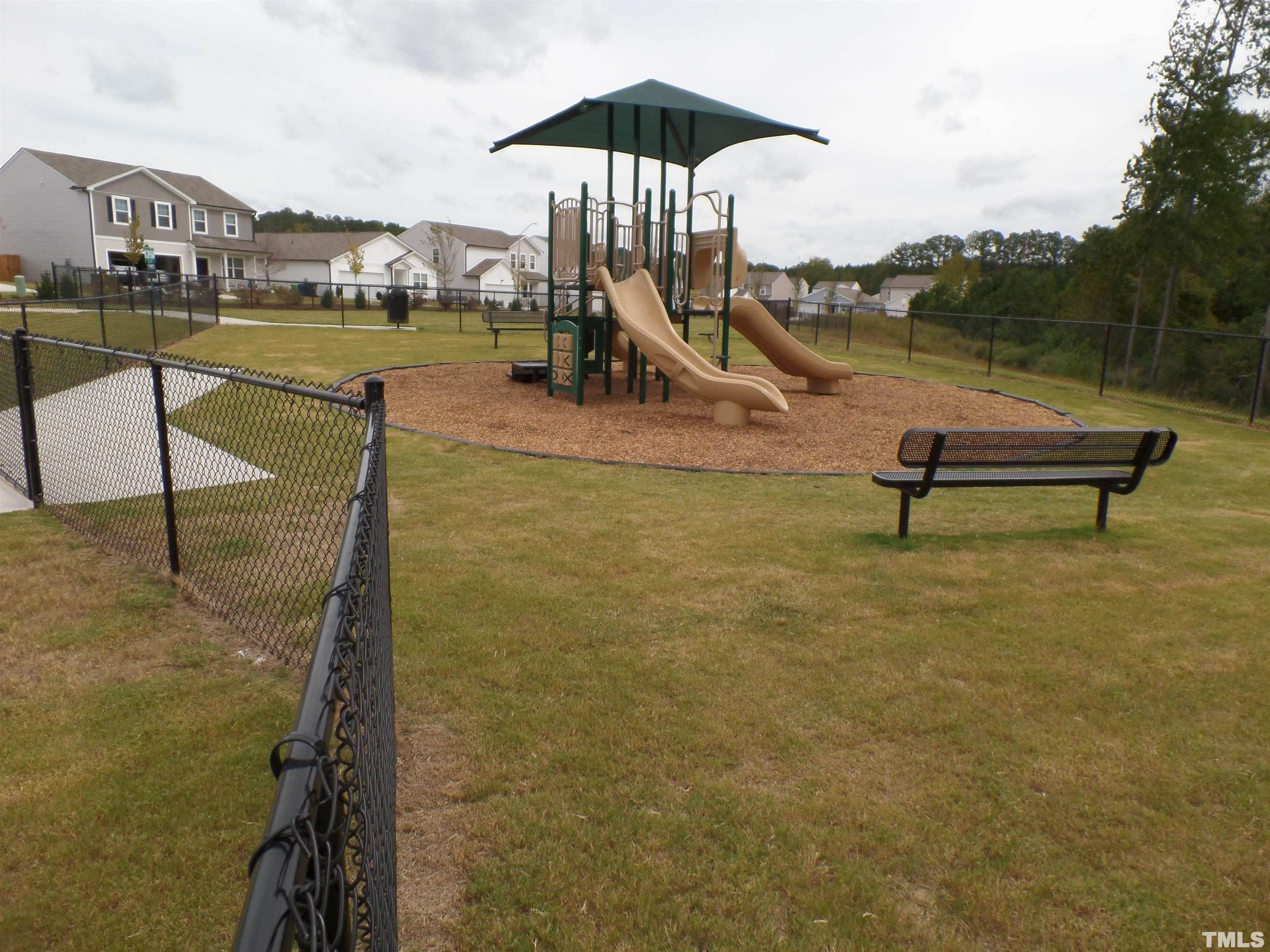 1632 Arapahoe Ridge Drive Raleigh, NC 27604 - Photo 27 of 28 a view of a lake with a table and chairs