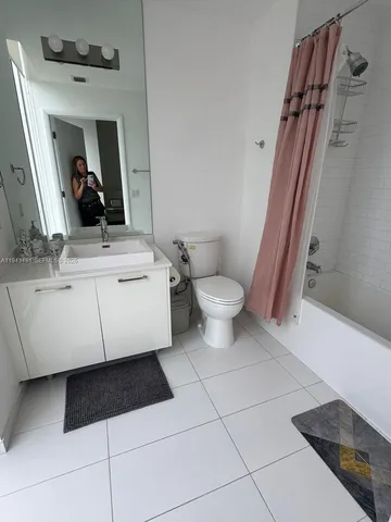 a bathroom with a sink a toilet and mirror