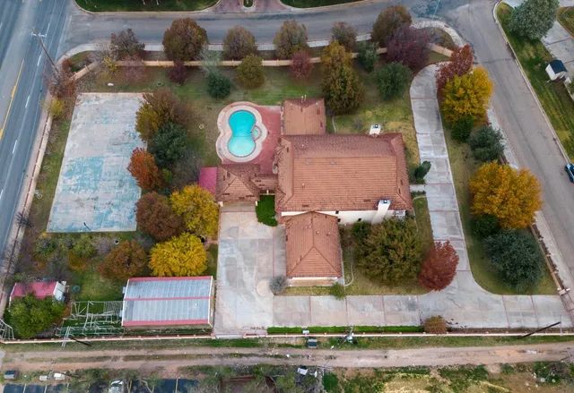an aerial view of a house with a swimming pool
