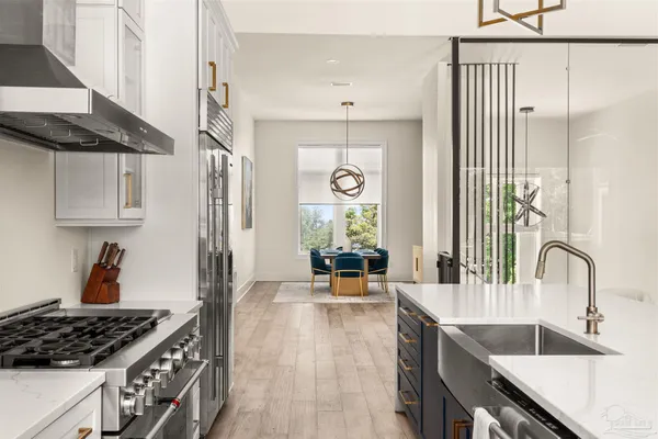 a kitchen with white cabinets and white appliances