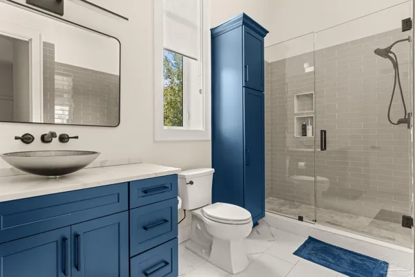 a spacious bathroom with a double vanity sink and a mirror