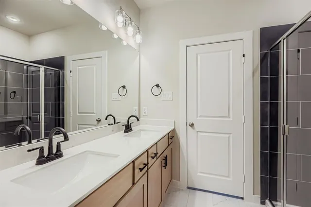 a bathroom with a sink double vanity and a mirror