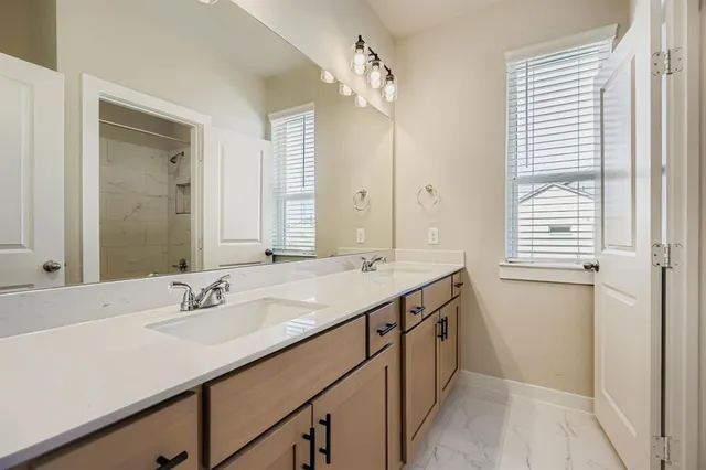 a bathroom with a sink double vanity and a mirror