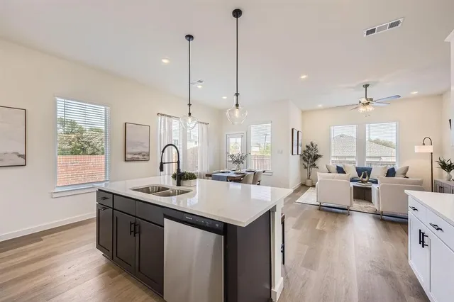 a open kitchen with stainless steel appliances granite countertop a sink stove and wooden floor