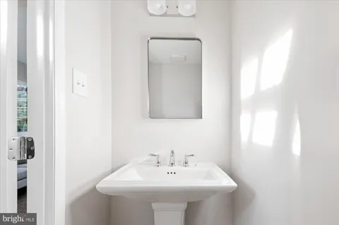 a bathroom with a sink a mirror and vanity