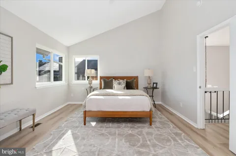 a bedroom with a bed and painting on the wall