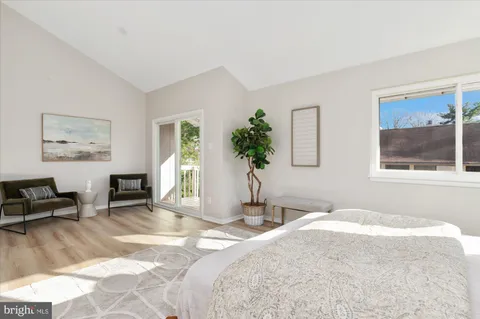 a bedroom with a bed a table and chair