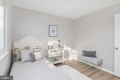 a spacious bedroom with a bed and a window