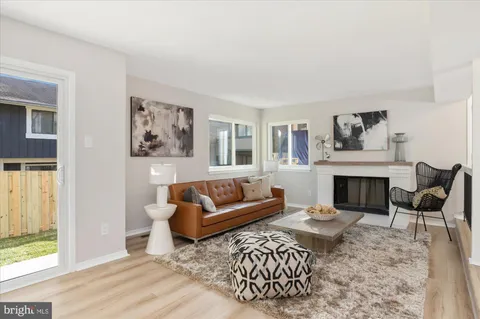 a living room with furniture a rug and a fireplace