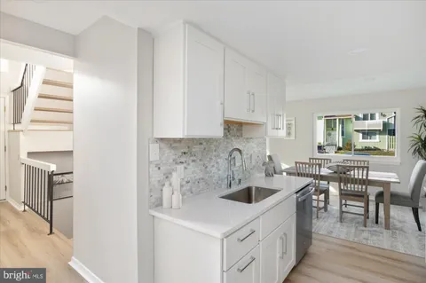 a kitchen with a sink a stove and cabinets