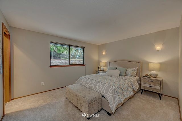 a bedroom with a bed and a night stand