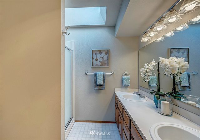 a bathroom with a sink and mirror with toilet