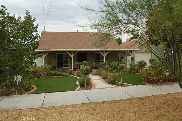 a front view of a house with a garden