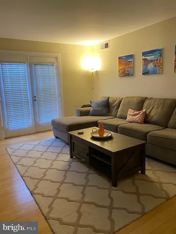 a living room with furniture and a rug