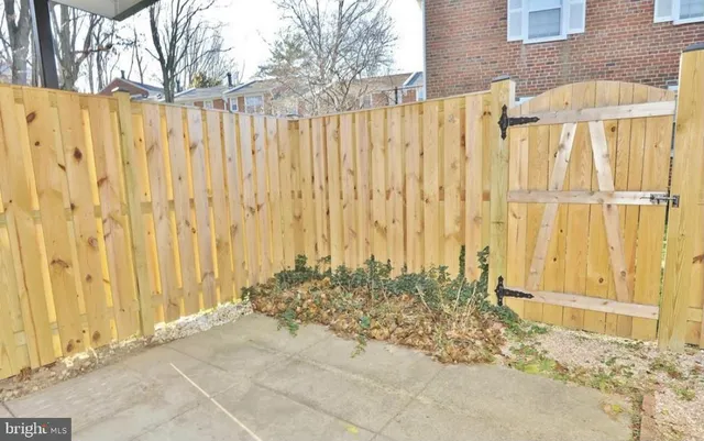 a view of a pathway with a wooden fence