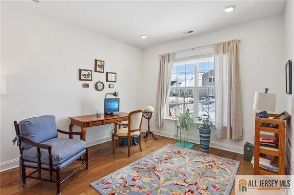 a living room with furniture and a rug