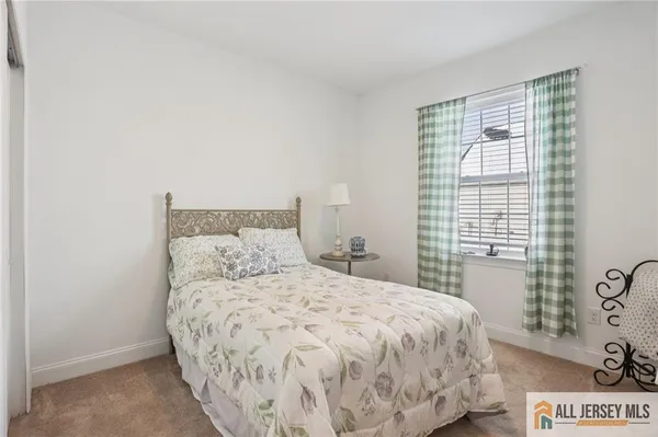 a bedroom with a bed and with windows