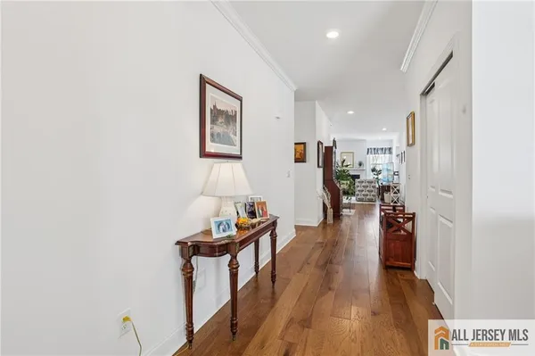 a view of a living room with furniture and wooden floor