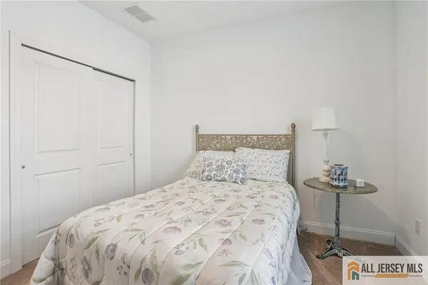 a bedroom with a bed and a table in it