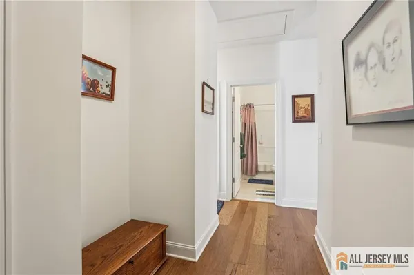 a view of a hallway with wooden floor and entryway