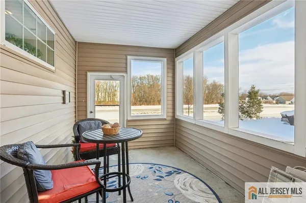 a view of a room with furniture and wooden floor