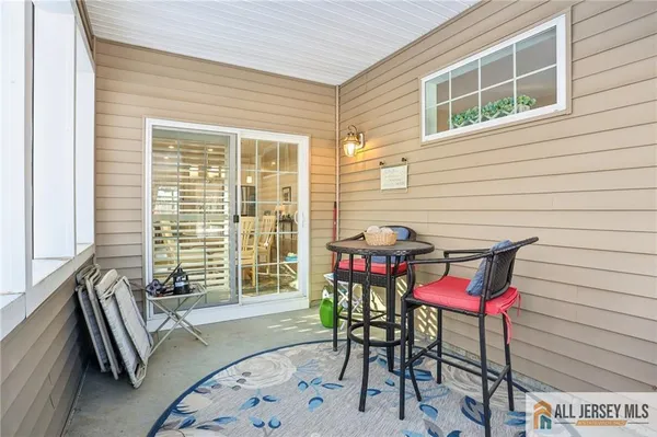 a view of a chairs and table in the balcony