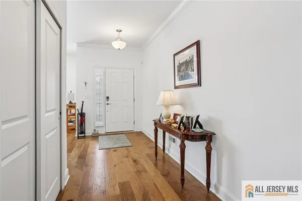 a view of a hallway with wooden floor