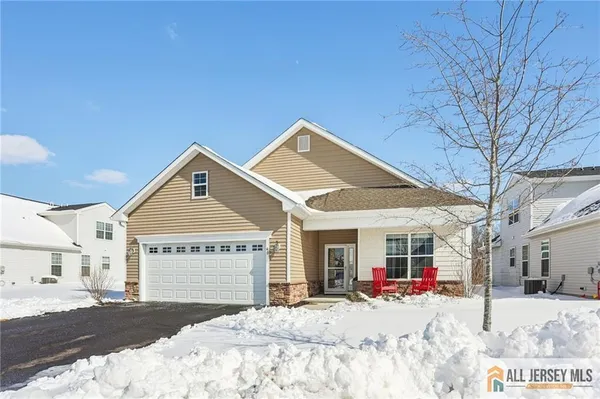 a view of a house with snow on the road