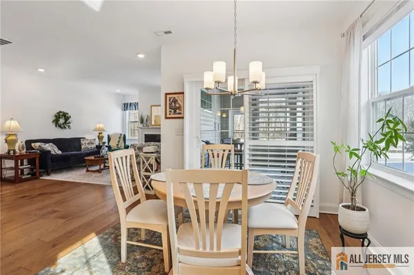 a view of a dining room with furniture wooden floor and chandelier