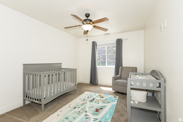 7797 North Windhover Road Eagle Mountain, UT 84005 - Photo 23 of 33 Carpeted room with a ceiling fan, recessed window, and neutral wall tones