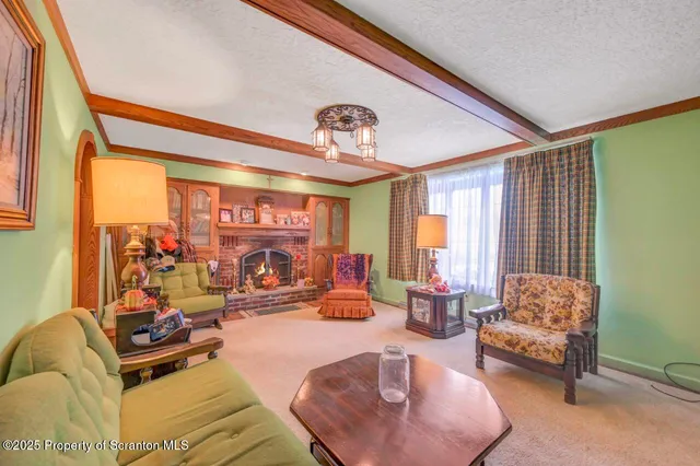 a view of a dining room with furniture one side kitchen view and wooden floor